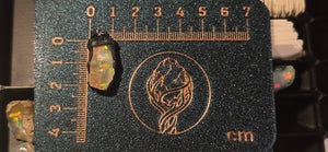 Raw uncut Ethiopian Welo opal pendant. Colour: multicolour, vivid. Body: light, deeper than usual. Placed next to a steel ruler for scale.