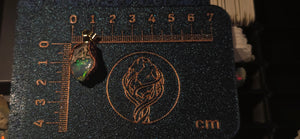 Raw uncut Ethiopian Welo opal pendant. Colour: full rainbow, vivid. Body: blue. Placed next to a steel ruler for scale.