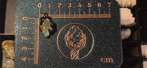 Raw uncut Ethiopian Welo opal pendant. Colour: full spectrum, vivid. Body: clear. Placed next to a steel ruler for scale.
